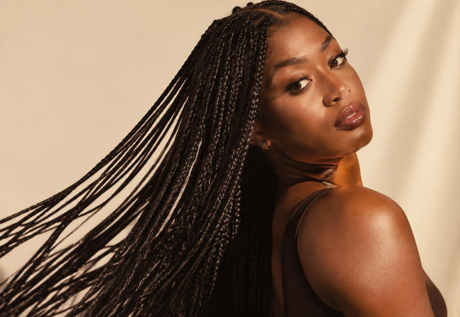 Model wearing waist-length knotless box braids